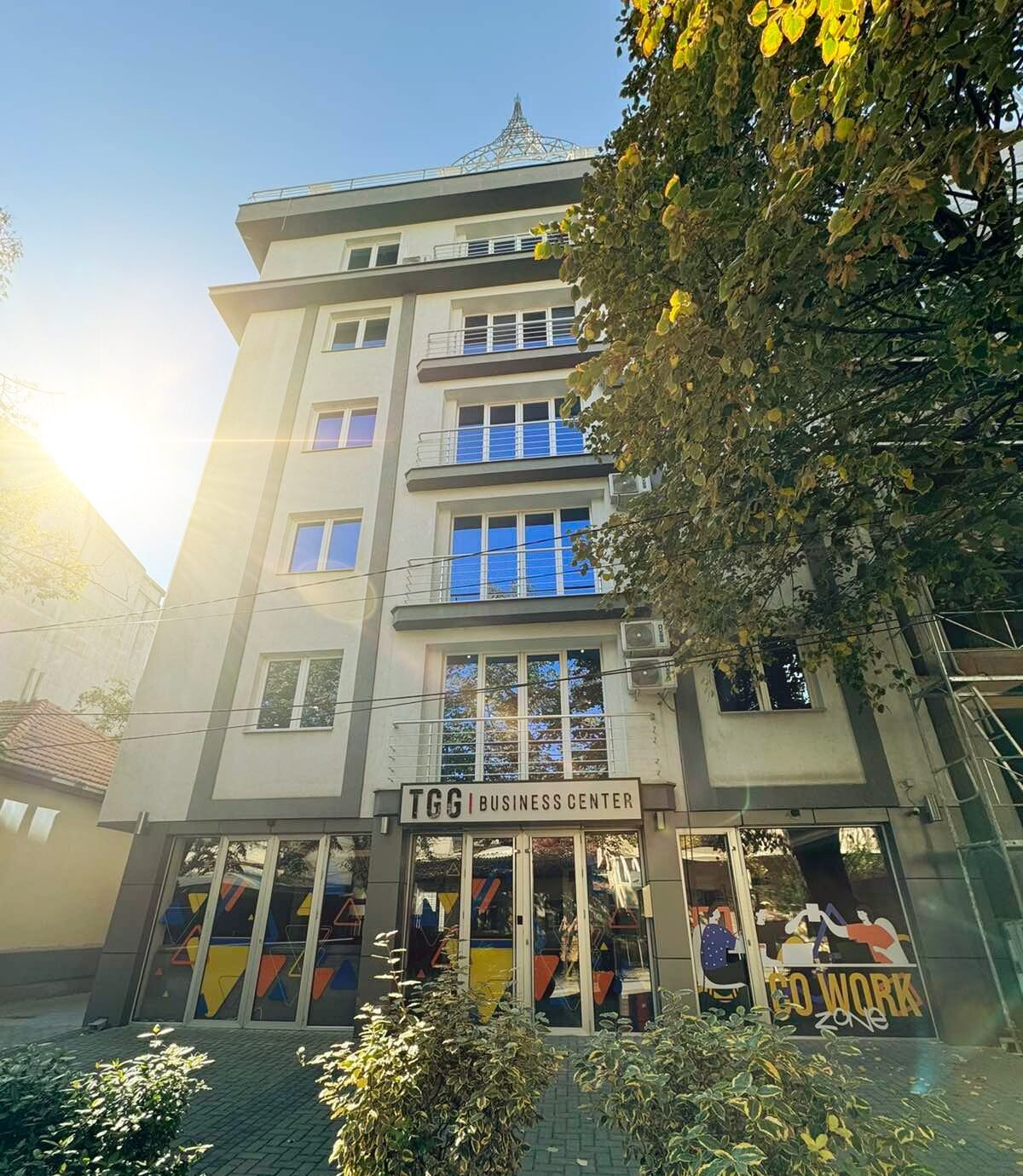 Facade of the TGG Business Center building at Pirinska 29 in autumn sunlight
